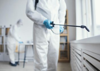 people-disinfecting-biohazard-area